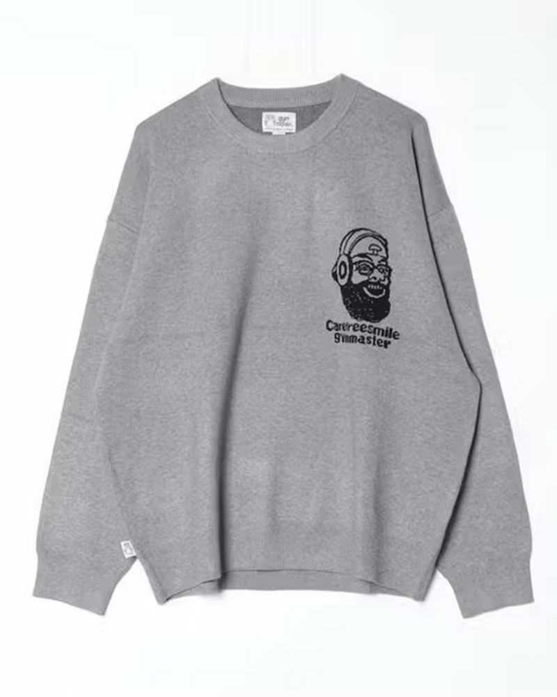gym master（ジムマスター）のcarefree smile ジャガードニットクルーネック。笑顔モチーフをジャガードで表現したグレー・ブラック・グリーンの3色展開ニット。